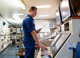 1881193483 Marine,Engineer,Working,On,Radio,Communication,At,Engine,Control,Room